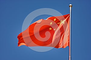 Flag of the Peoples Republic of China against the blue sky