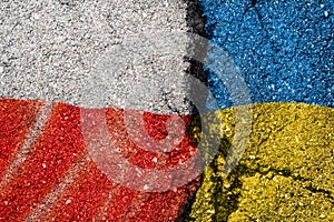 Flag of Poland and Ukraine on the asphalt texture