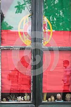 The Flag of Portugal in window in Faro city