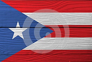 Flag of Puerto Rico on wooden wall background. Grunge Puerto Rico flag texture.