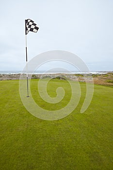 Flag and Putting Green on Coastal Golf Course