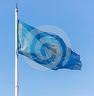 Flag of the Republic of Kazakhstan waving in the wind against the blue sky