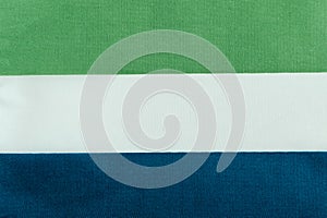 Flag of the Republic of Sierra Leone on a textile basis close-up