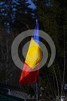 The flag of Romania hoisted at a Gura Diham chalet, Bucegi, Romania.