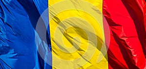 The flag of Romania in the wind. Waves. Red, yellow and blue.Close up