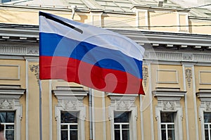 Flag of Russia with black mourning ribbon.