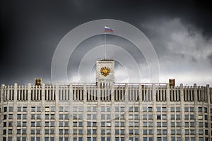 The flag of Russia and The coat of arms of the Russian Federation on the top of The House of the Government of the Russia