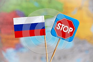 Flag of Russia and stop sign over the world map. Stop war and aggression concept