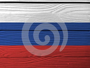 Flag of Russia on wooden wall background. Grunge Russian flag texture.