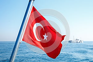 The flag scene from Turkey. The Turkish flag is fluctuating in the ferry on the sea