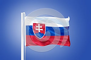 Vlajka Slovenska lietajúca proti modrej oblohe