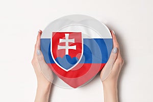 Flag of Slovakia on a heart shaped box in a female hands. White background