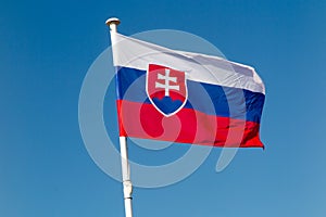 The flag of Slovakia waving under blue sky