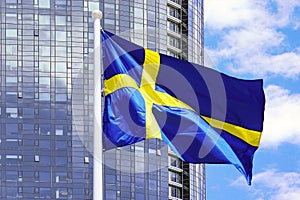 Flag Sweden on the background of a modern building