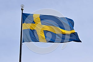 Flag of Sweden on flagpole in wind