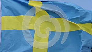 The flag of Sweden waves in the wind in slow motion