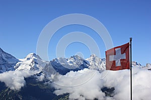 Flag of Switzerland against Swiss Alps