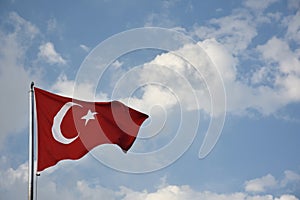 Flag of Turkey developing against a clear blue sky