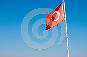 Flag of Turkey on the mast. The Turkish flag flies against the blue sky