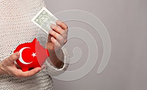 Flag of Turkey on money bank in Turkish woman hands. Dotations, pension fund, poverty, wealth, retirement concept