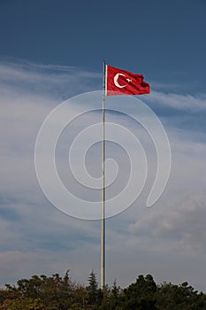 Turkish flag, flag pole, blue sky.