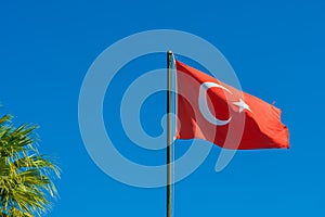 Flag of Turkey rise waving to the wind with sky in the background. Waving national flag of Turkey