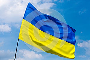 Flag of Ukraine against the blue sky. Horizontal shot.