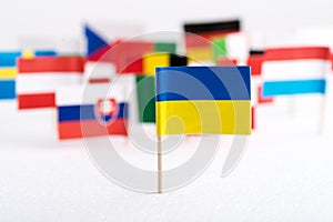 Flag of Ukraine is close-up against the background of the flags of European countries. European countries do not accept Ukraine