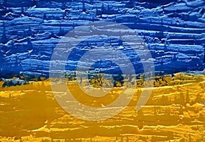 Flag of Ukraine on old grunge wall in background.