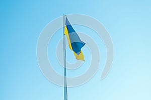 flag of Ukraine on a pole against the sky