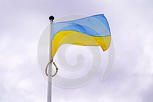 Flag ukrainian National state flag of Ukraine in yellow blue banner on cloudy dark sky