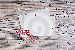 Flag of United Kingdom of Great Britain in hand on white wooden background top view. copy space. the concept of independence day,