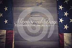 The flag of the United Sates on a grey plank background with memorial day