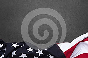 The flag of the United States of America on a gray textured background with copy space