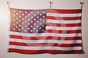 Flag United States America is suspended on white wall.