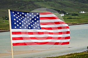 Flag of United States of America waving in a wind. Green mountains in the background. USA symbol in nature environment. Rural area