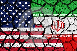 Flag of the United States and Iran on the texture of the cracked dry earth.