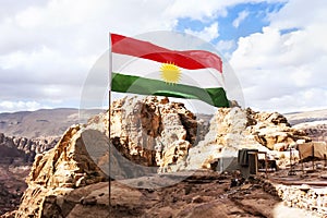 Flag of unrecognized Republic of Kurdistan in the mountains against the sky and nature of the middle East photo