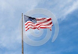 Flag of the USA. National waving flag of united states on blue sky. Independence day. Patriotic symbol. American Flag