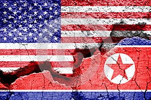 Flag of USA and North Korea on a cracked background. Concept of conflict between two nations, Washington and Pyongyang