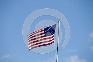 Flag of USA waving against blue sky