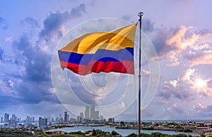 Flag wavering in front of scenic view of Cartagena modern skyline near historic city center and resort hotel zone