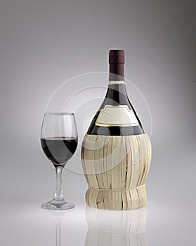 Flagon of red wine with glass