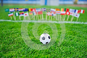 Flags of all football nations on green grass. Football ball, Fans, support photo, edit space