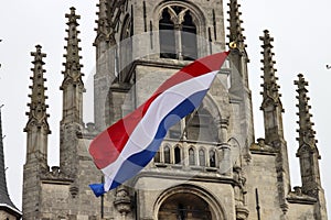 Flags on the ancient town hall at the Markt of Gouda during celebration of 750 years Gouda