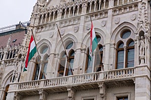 Flags on the beautiful old building of the Hungarian Parliament in neo-Gothic style