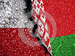 Flags of Belarus and Poland on a stone background. Refugees on their way to the EU.