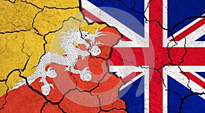 Flags of Bhutan and United Kingdom on cracked surface