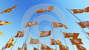 Flags with Bit coin blockchain Crypto currency sign against blue sky.