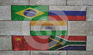 flags of brics states on brick wall conceptual photo